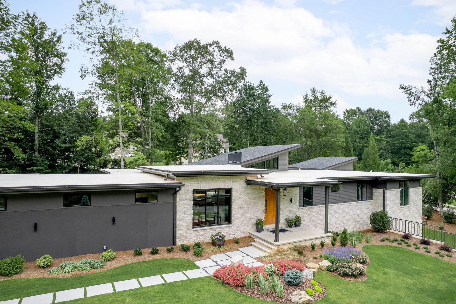 Front elevation with walkway and flower beds — The Ortiz Home, custom home built by Ironwood Construction Group in Sugar Hill, Georgia