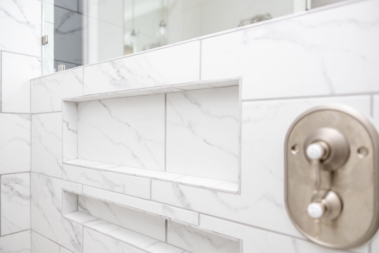 Marble shower niche and shower valve detail — Shadburn Ferry, custom home built by Ironwood Construction Group in Buford, Georgia