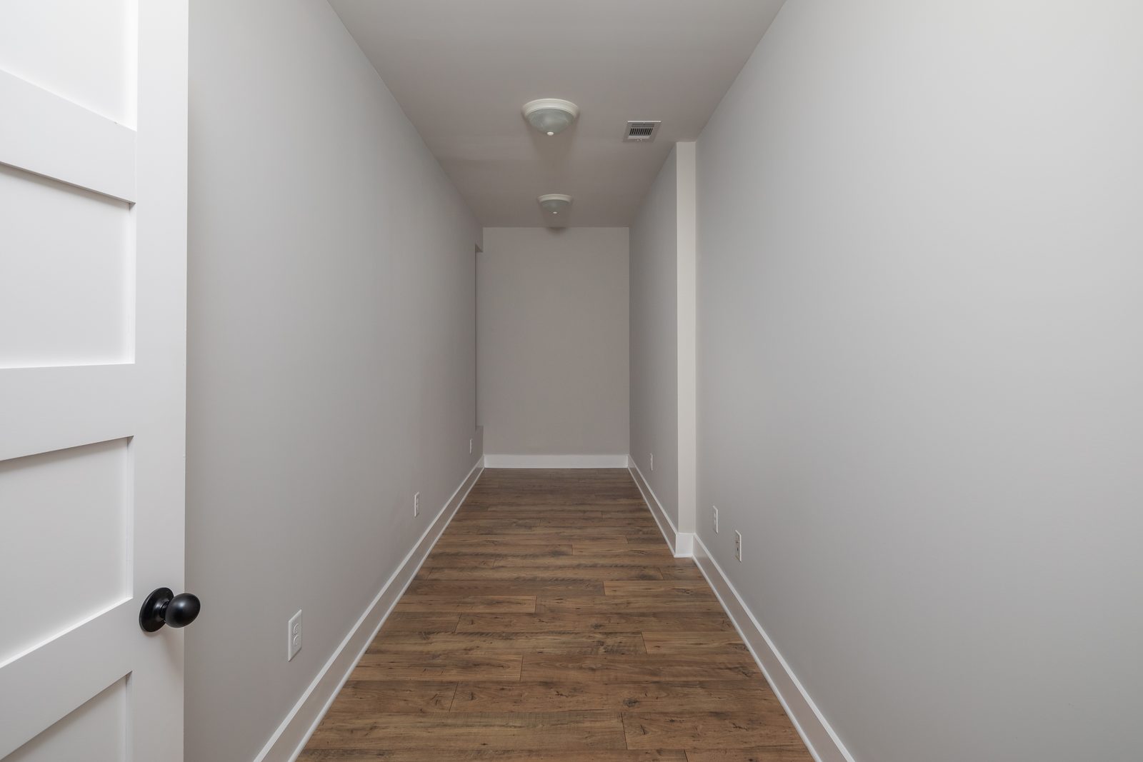 Upstairs hallway with hardwood floor — Shadburn Ferry, custom home built by Ironwood Construction Group in Buford, Georgia